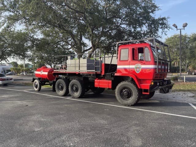 Fire rescue military-style truck with department graphics by ATD Suncoast