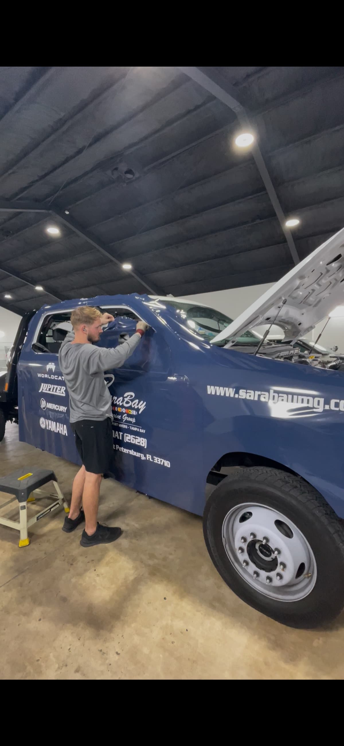 Vehicle wrap technician wrapping truck by Auto Trim Design Bradenton