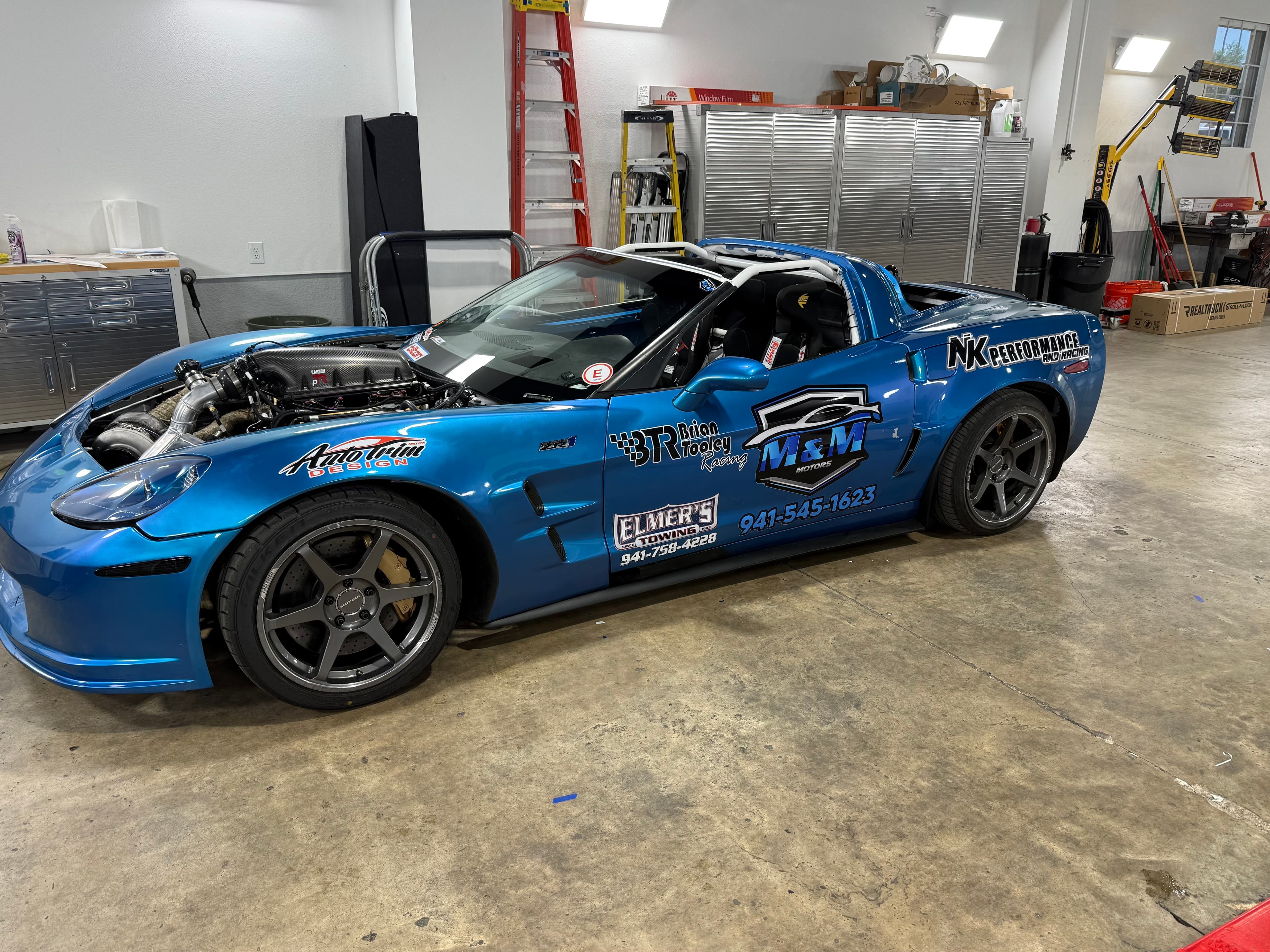 Blue Corvette race car with sponsor graphics and lettering by ATD Suncoast