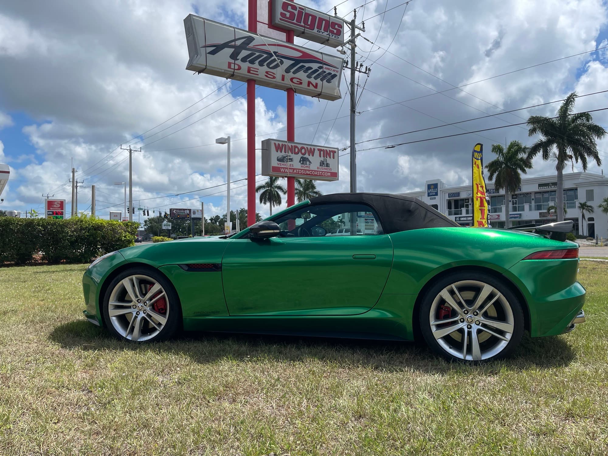 Green Jaguar F-Type wrap in front of Auto Trim Design sign